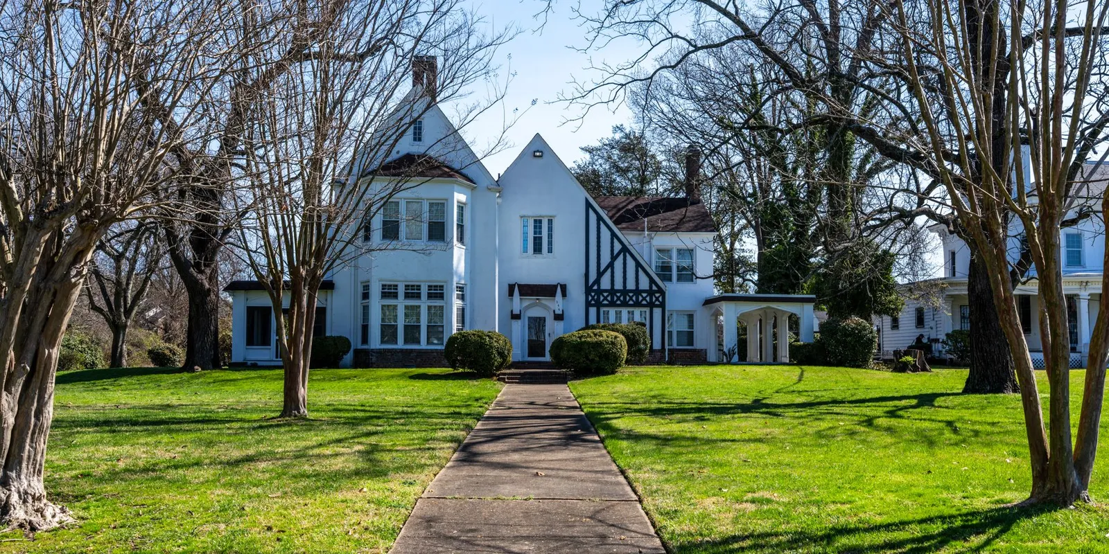 Elegant Tudor Revival home representing properties represented by Tarik Real Estate